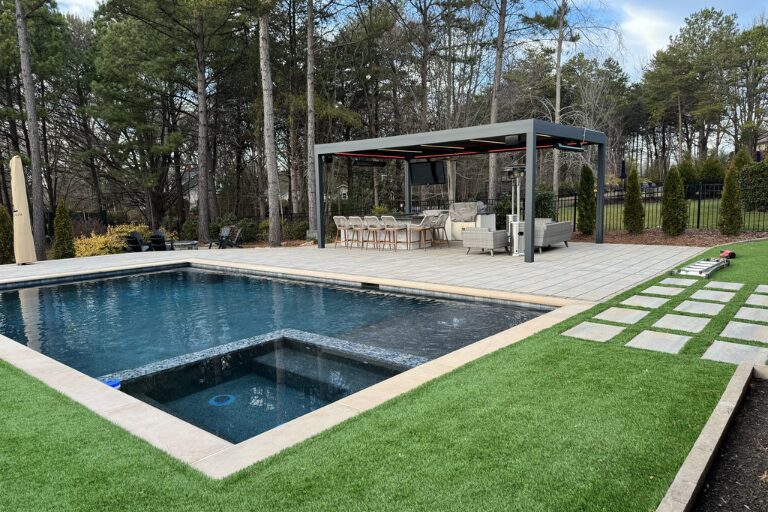 Louvered pergola system designed to provide shade and control over the outdoor environment beside a pool