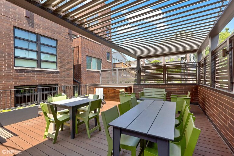 Trex roof deck featuring a custom louvered pergola